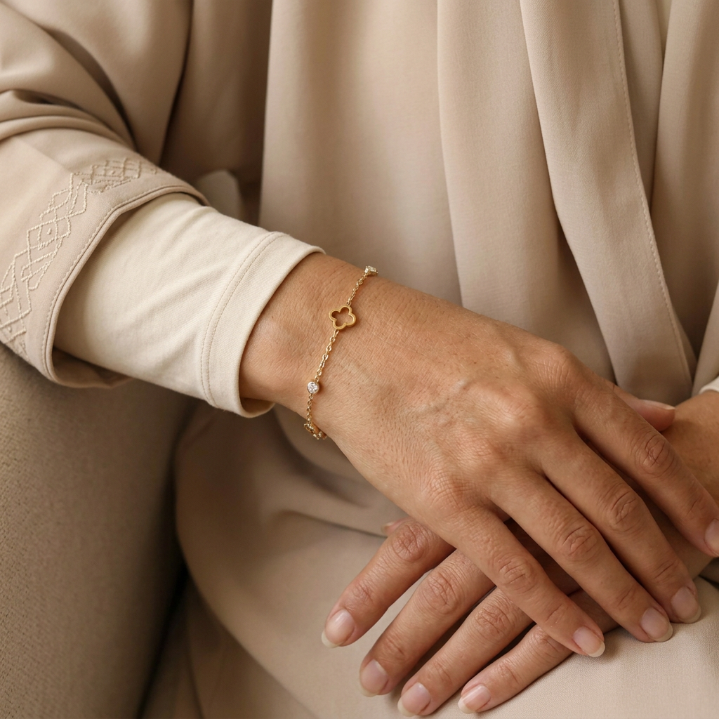 Model wearing the bracelet with a modern sand-beige abaya