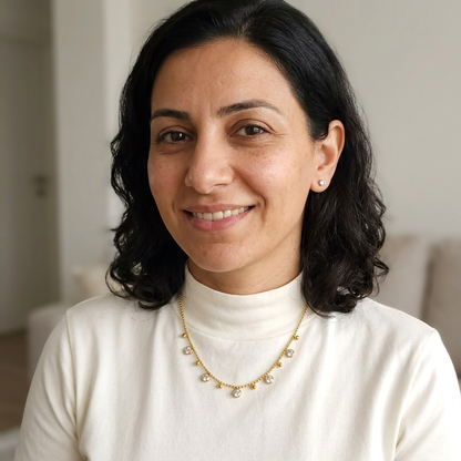 Natural smiling woman wearing the necklace and one crystal stud in each earlobe
