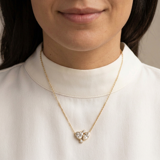 Tight jewelry-focused crop from the model’s lips to below the pendant