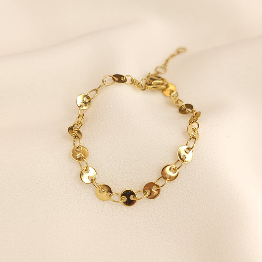 Children's Coin Bracelet arranged in a circle, featuring polished gold-tone discs joined by oval links.