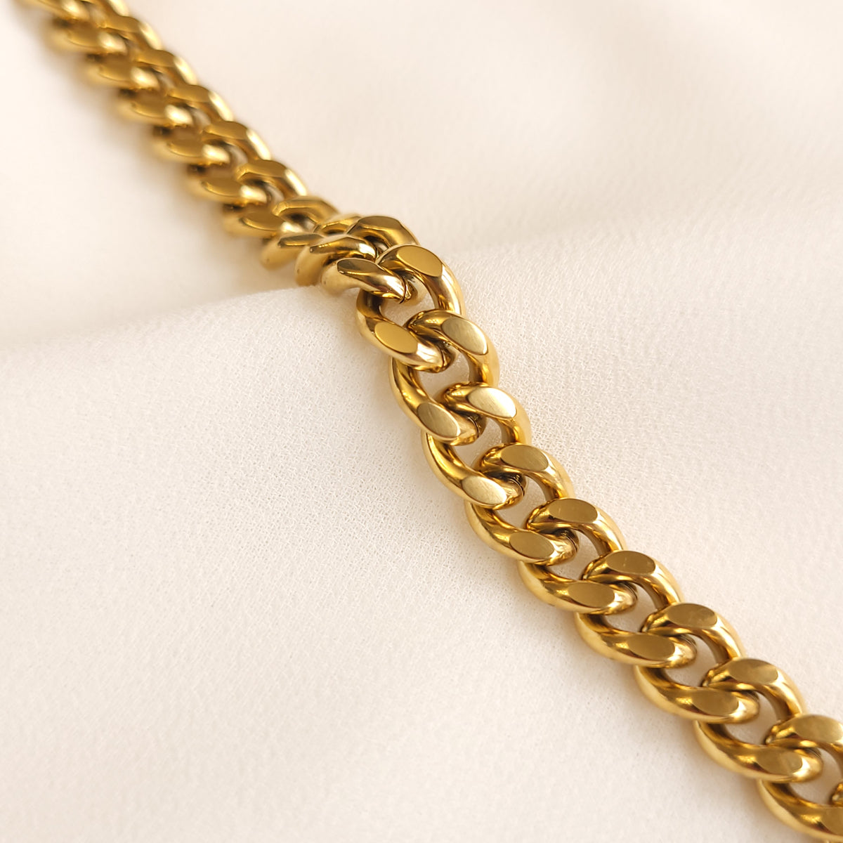 Chunky Cuban Chain Bracelet close-up showing the thick, interlocking gold-tone curb links.
