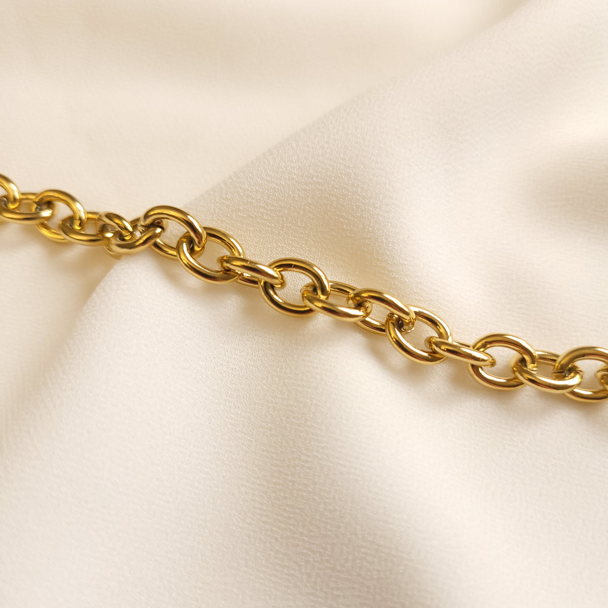 Circle Link Bracelet close-up showing the polished, rounded gold-tone links and their interlocking pattern.