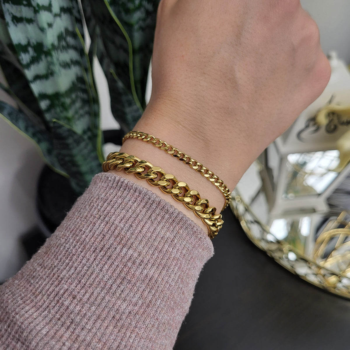 Dainty Cuban Chain Bracelet worn beside a chunky gold-tone Cuban bracelet to compare their widths.