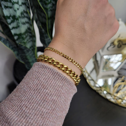 Dainty Cuban Chain Bracelet worn beside a chunky gold-tone Cuban bracelet to compare their widths.