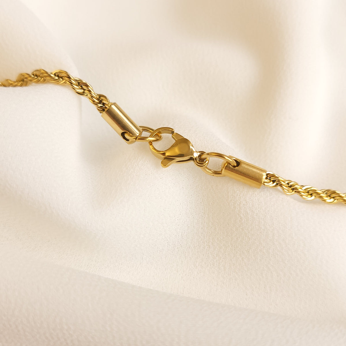 Essential Rope Necklace fastening detail showing the gold-tone lobster clasp and cylindrical end caps.