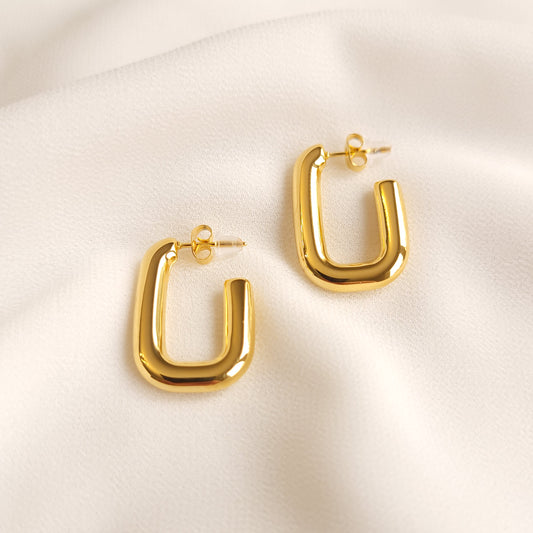 Geometric Square Earrings shown as a pair, featuring thick gold-tone U-shaped hoops with rounded corners and butterfly backs.