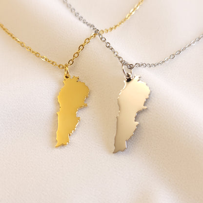 Gold-tone and silver-tone Lebanon map pendant necklaces displayed side by side.
