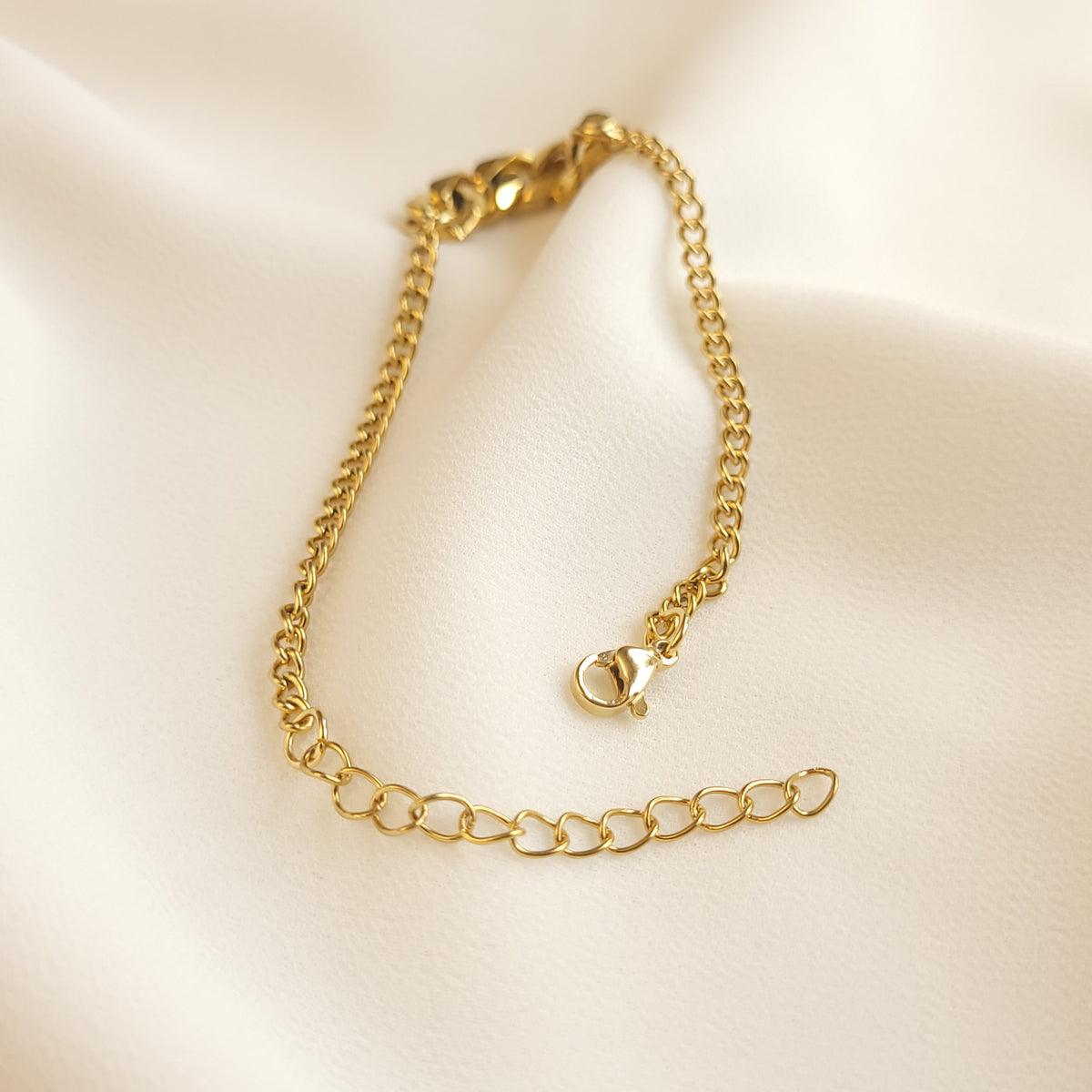 Mixed Cuban Bracelet laid open to show the fine curb chain, lobster clasp, and adjustable extension chain.
